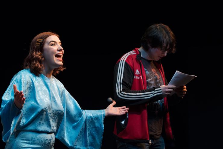 student comedy performers emote onstage 