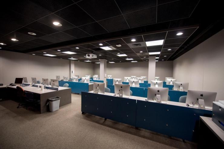 a large room with rows of iMac computers