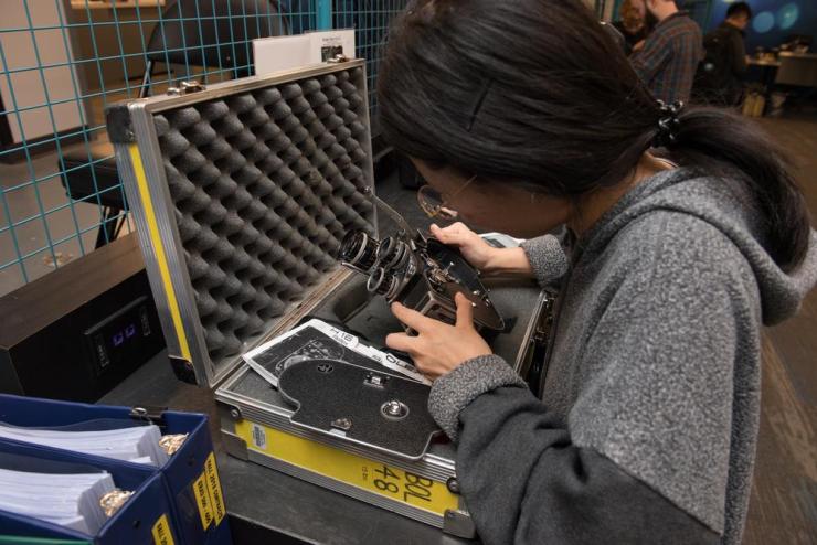 A student working on a camera at the Equipment Distribution Center
