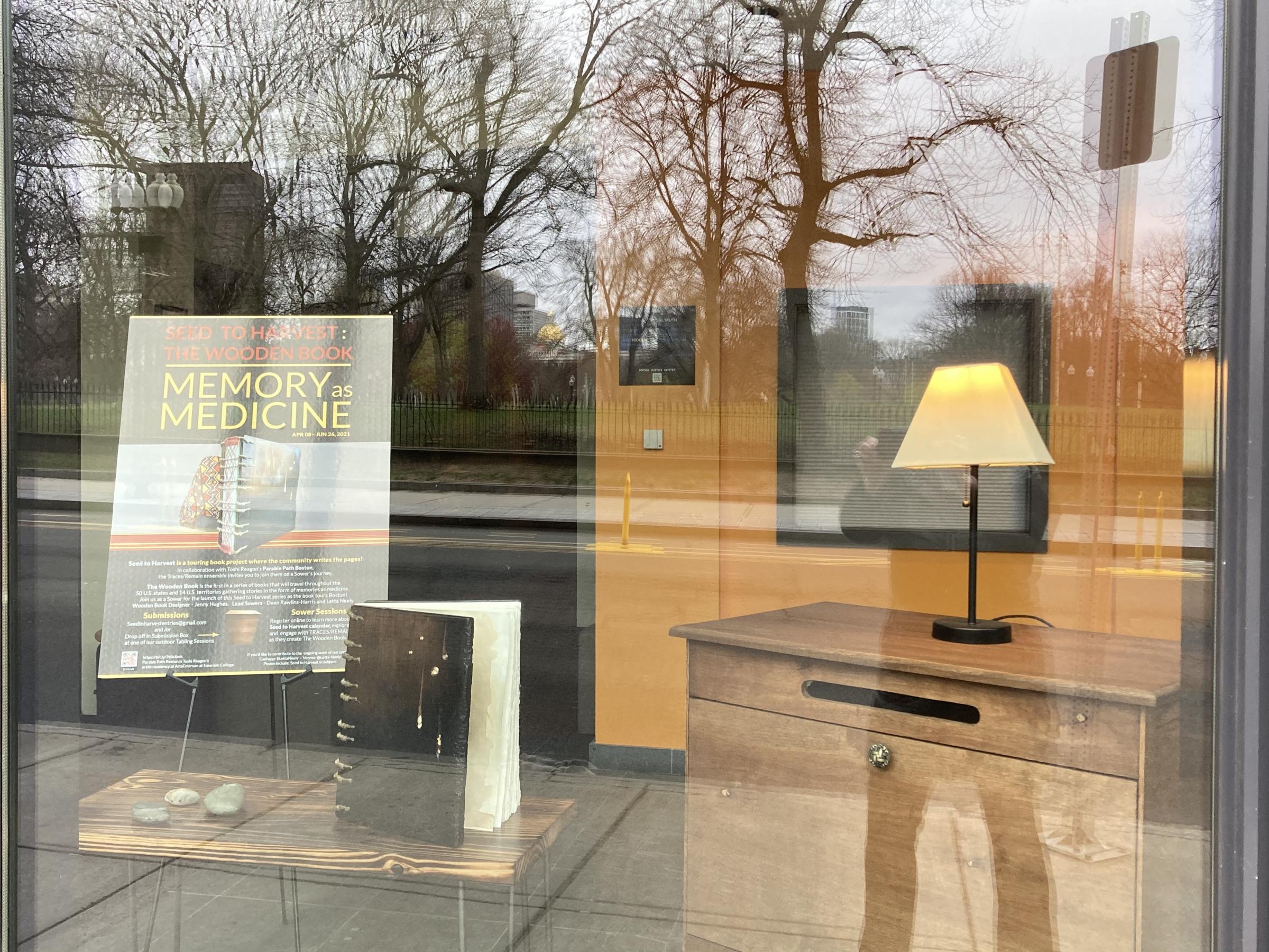 Blurry shot of Memories as Medicine Wooden Book in the front window of the ELC