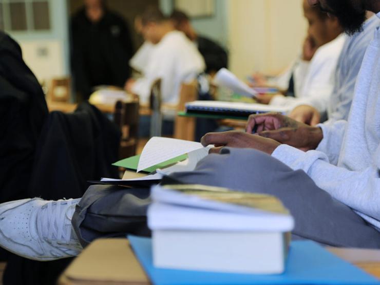 A closeup of a student working at their desk