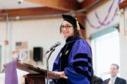 Mneesha Gellman, Founder of EPI, standing at a lectern during the 2025 Commencement ceremony for EPI graduates