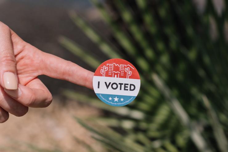 Person holding "I voted" sticker (Photo Credit to Phillip Goldsberry from unsplash.com)