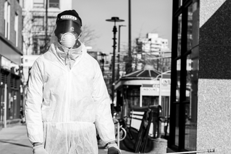 Black and white photograph of a person in a protective suit standing on Tremont Street
