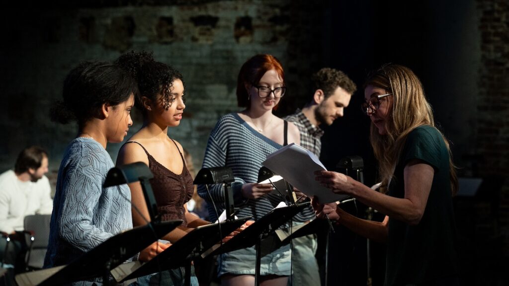 Actress Jane Leeves talks to students during the table reading of script|Students sit in chairs during a table reading of a script||||||
