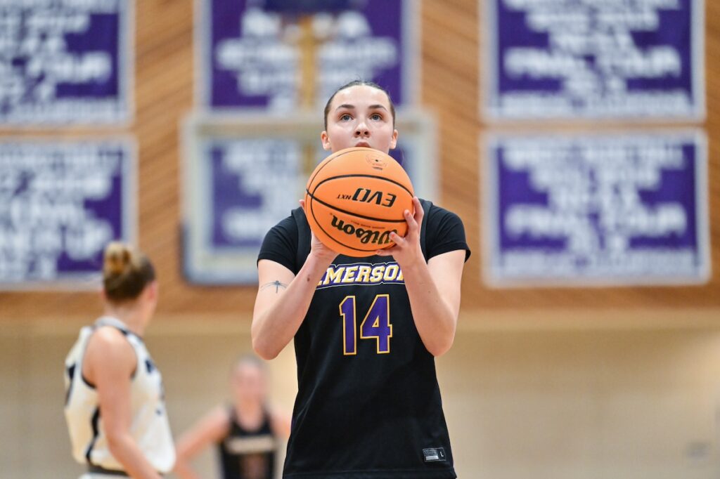 Kaylin O'Meara stands holding a basketball