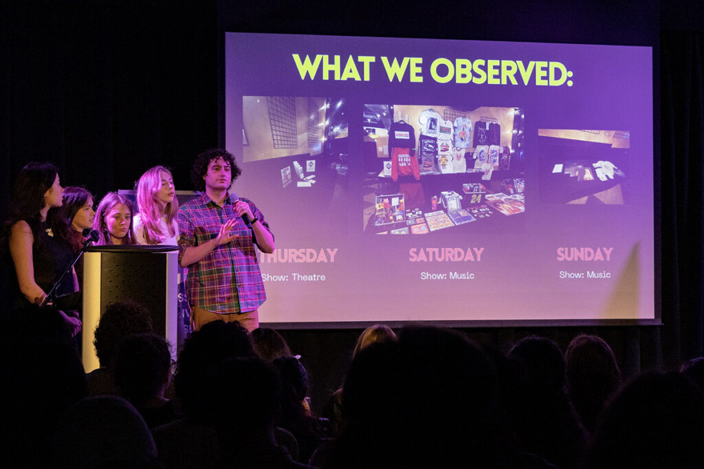 Four people on stage present their projects|||
